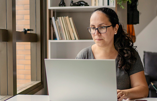 Researcher in her office working on laptop